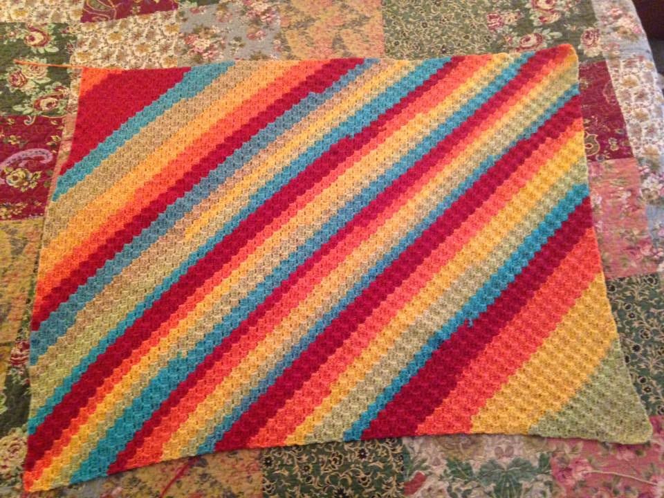 C2C crochet blanket with diagonal rainbow stripes, for the C2C crochet calculator