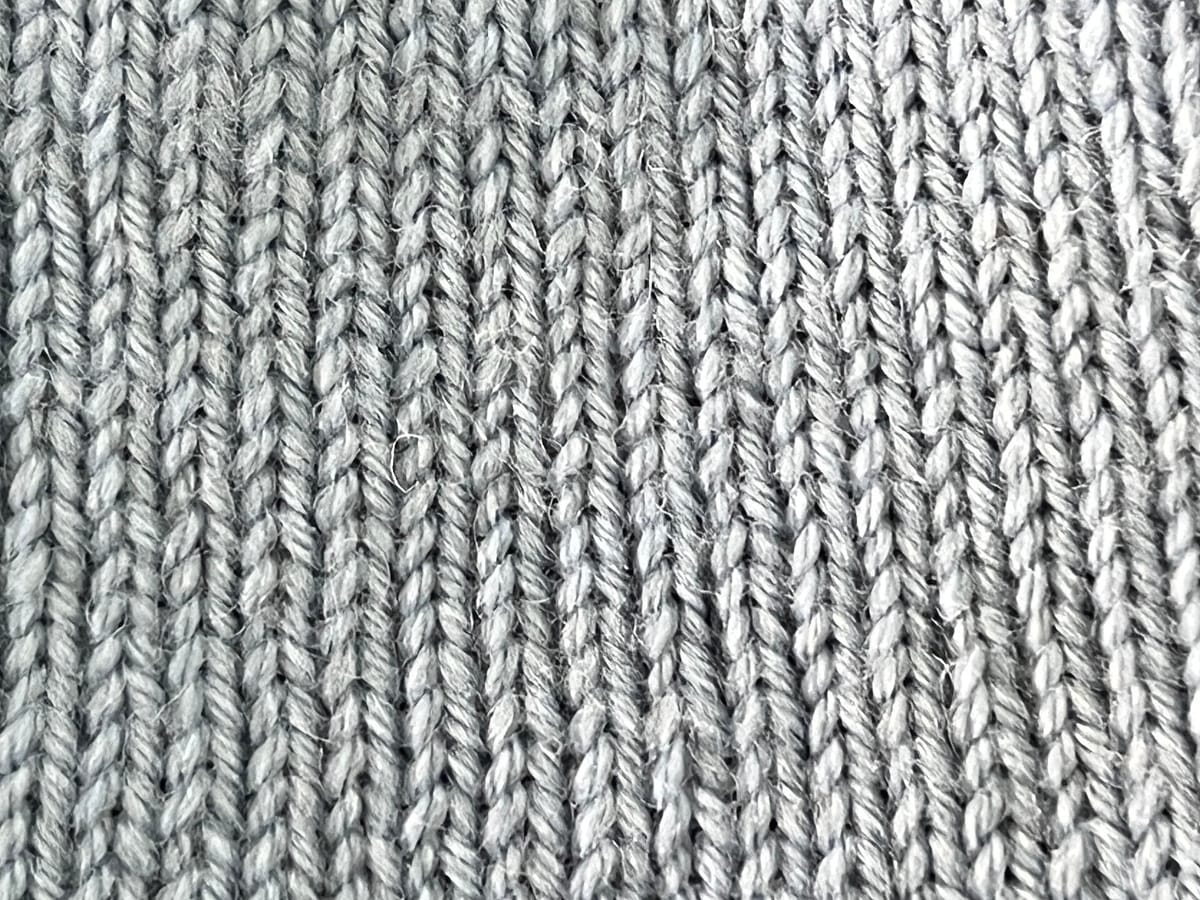 Close-up of a knitted stockinette swatch, the fabric you measure with a knitting gauge calculator