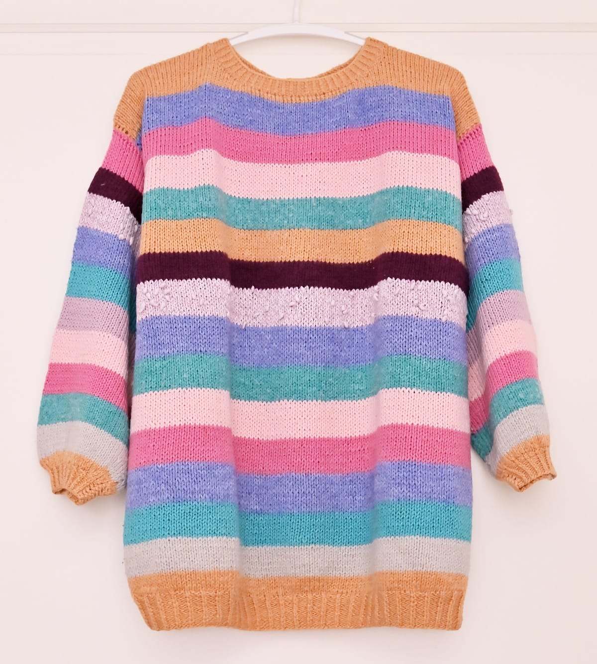 Hand-knitted striped pullover sweater in pastel colors, for the top-down raglan sweater calculator